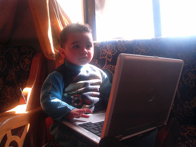 Photo of a baby working on a laptop