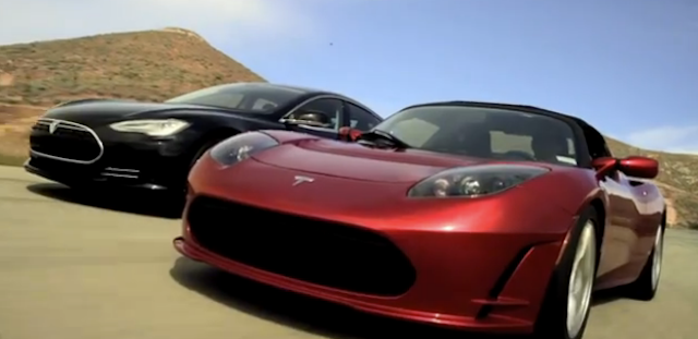 Tesla Model S and Roadster driving on a road together