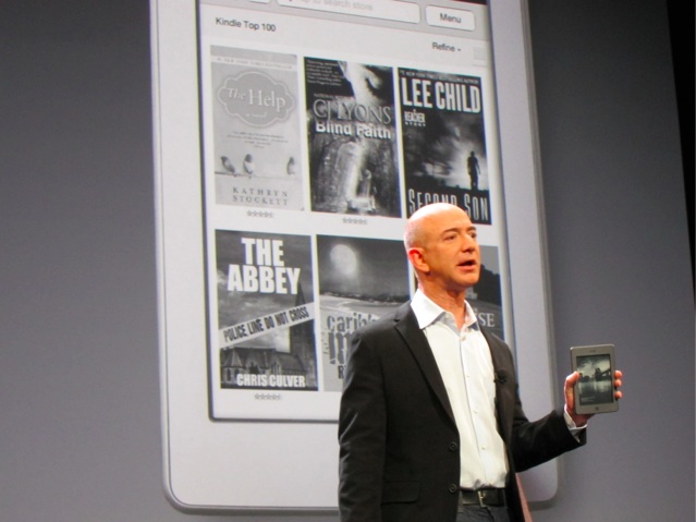 Amazon's Jeff Bezos holding a Kindle Touch