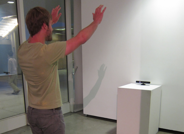 Person interacting with a Kinect in an art gallery