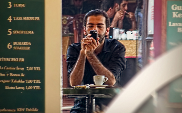 Man in Instanbul cafe using a cellphone