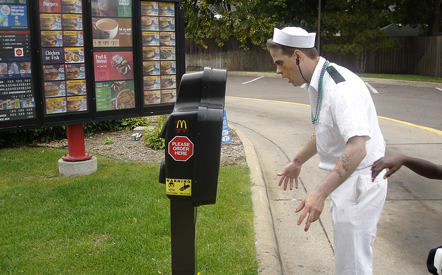 A zombie places an order at McDonald's. For BRAAAAIIIINS.