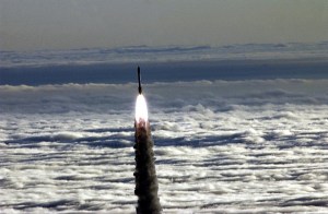 NASA photo of a rocket soaring above the clouds