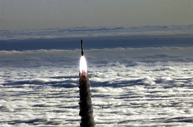 NASA photo of a rocket soaring above the clouds