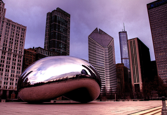 photo of Cloud Gate, a reflective sculpture, and the Chicago skyline