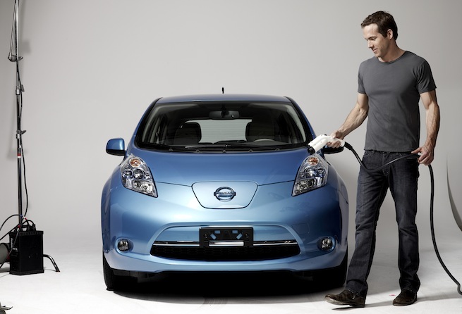 Actor and environmentalist Ryan Reynolds recharges an electric Nissan Leaf
