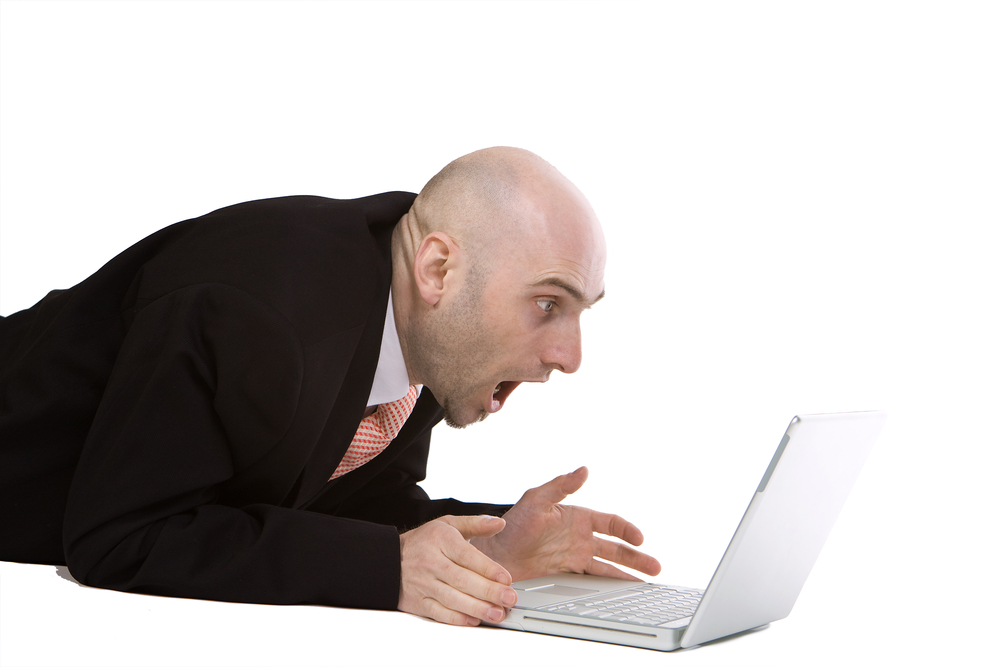 Shocked man with computer 