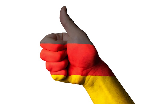 German flag laid over a thumbs-up hand