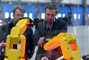 Elon Musk watches robots at the Tesla Motors plant (formerly NUMMI Plant)