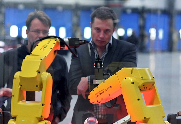 Elon Musk watches robots at the Tesla Motors plant (formerly NUMMI Plant)