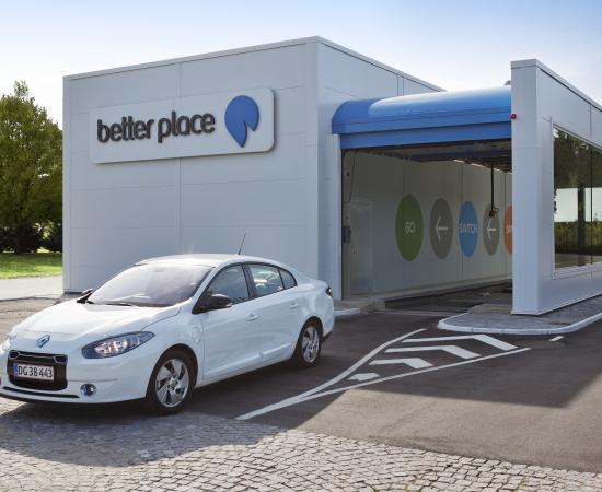 A Renault Fluence ZE electric car exits a Better Place battery switching station.