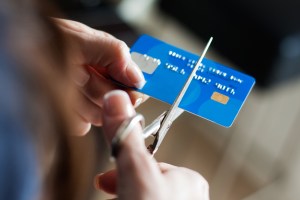Hands cutting a creditcard