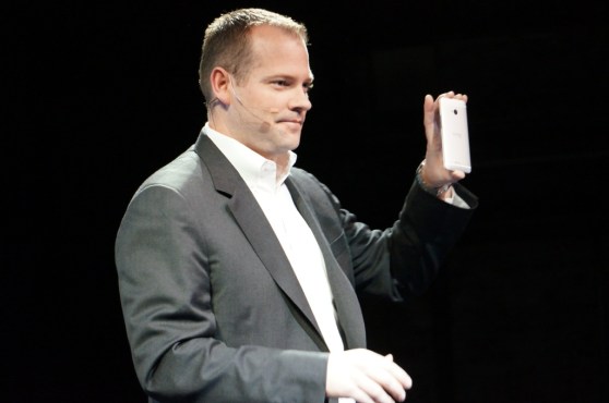 HTC president Jason Mackenzie holding an HTC One