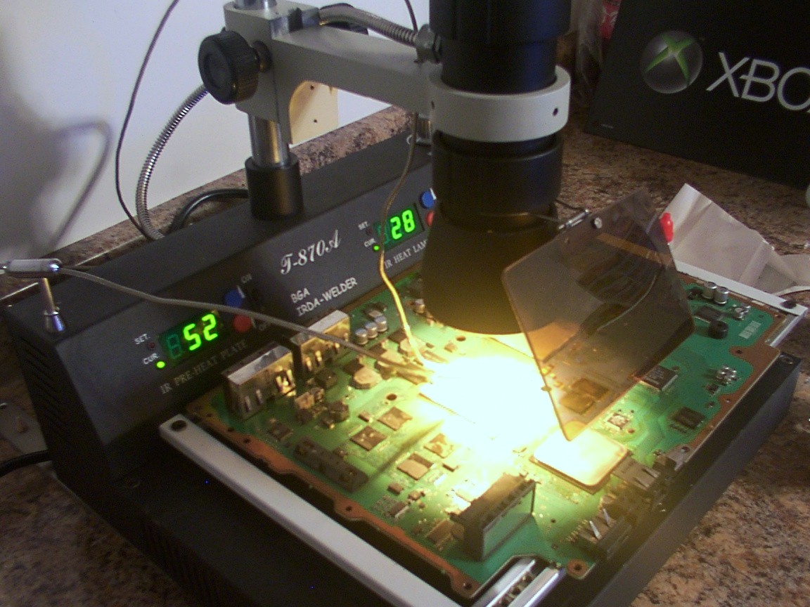 A PS3 motherboard under a heat gun.