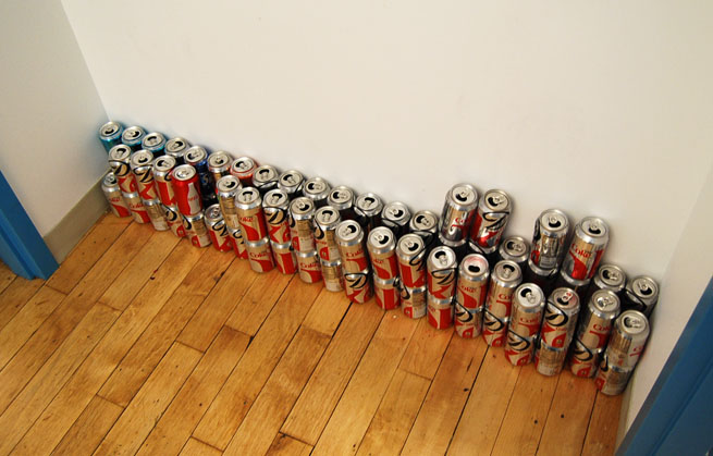 Diet Coke cans stacked in a hallway