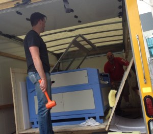 Roth and business partner Matt Stollenwerk unload a laser cutter for new business "SF Laser."