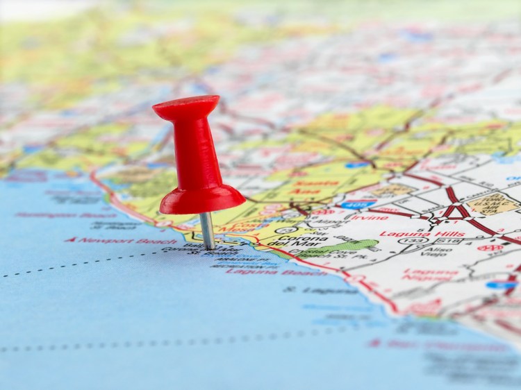 Closeup of a red pushpin on a map