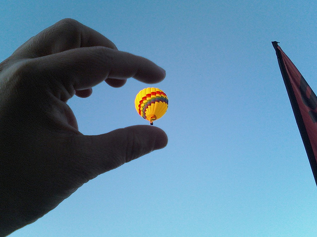 Pinch to zoom? Person trying to pinch a remote balloon