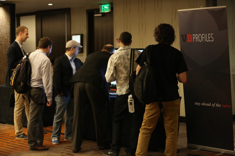People at the CloudBeat conference check out a demo of the new VentureBeat Profiles.