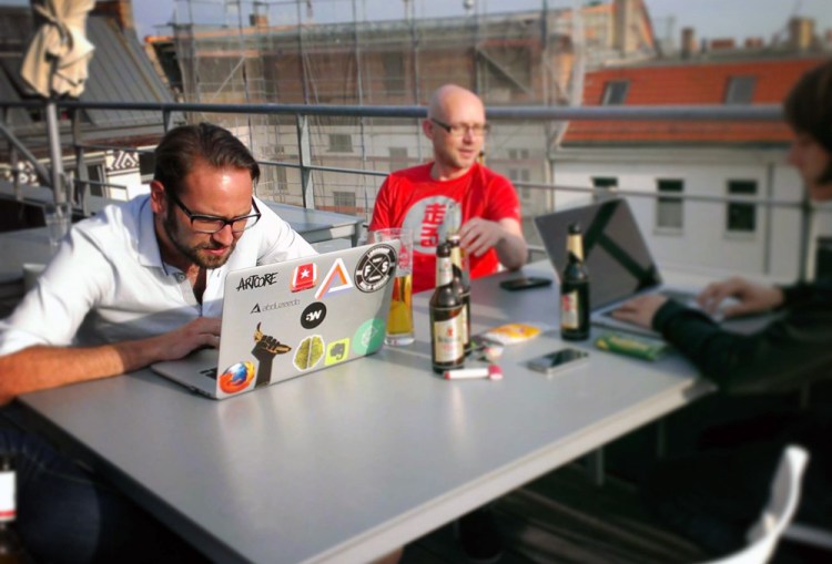 Members of the 6Wunderkinder team work on a Berlin rooftop