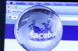 Facebook's webpage seen through a glass globe.