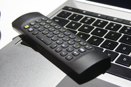 The remote for the Chromebox for meetings. One side has a keyboard. The other has buttons to control the box.