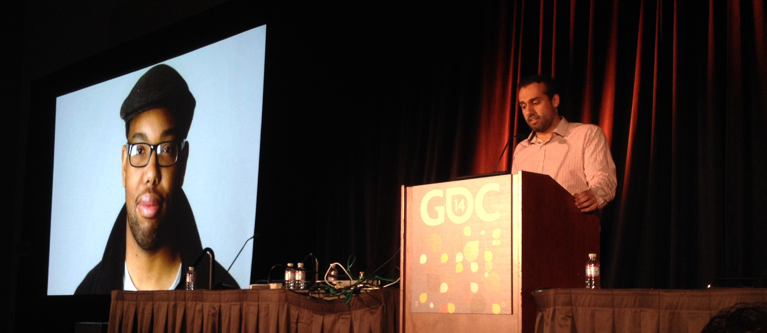 Manveer Heir standing at the podium while he delivers his GDC 2014 panel.