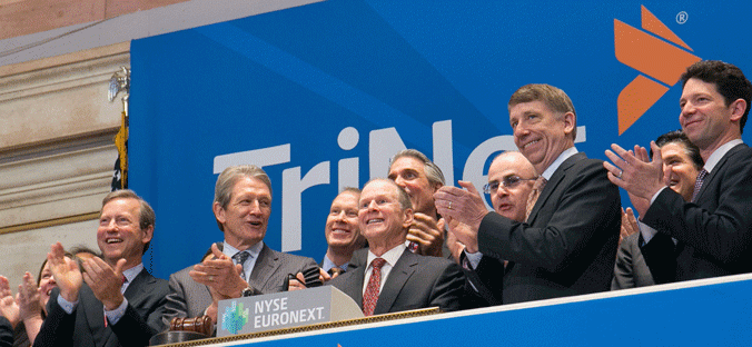 TriNet CEO Burton Goldfield grins at the New York Stock Exchange.