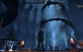 A third person view of a character staring at a Dark Achor, which is a vertical column of spiked circles and a glowing column of energy in the middle.