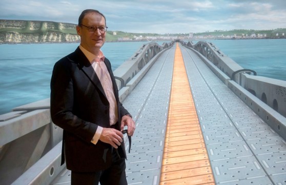 Tim Beckett stands before a re-creation of the Mulberry Harbor his father helped create.