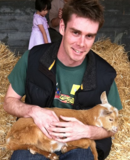 Ian Stocker holding some sort of adolescent farm animal.