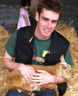 Ian Stocker holding some sort of adolescent farm animal.