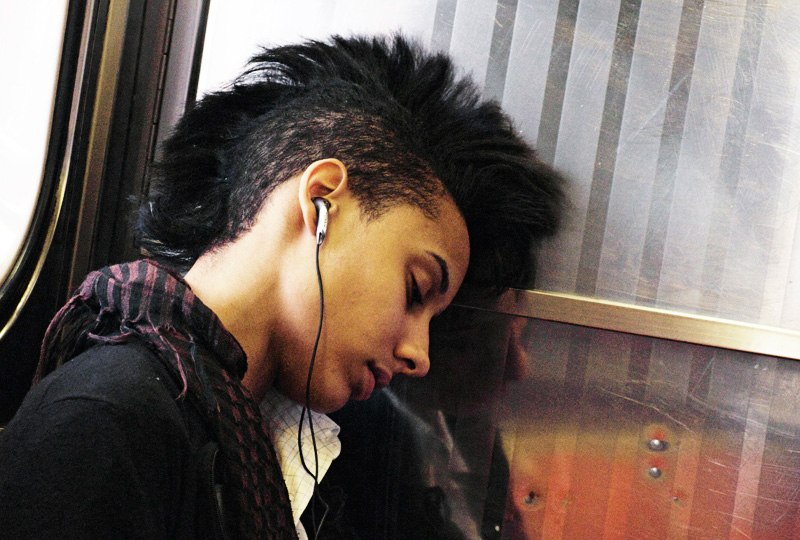 A woman sleeps on the '7' train in Queens, New York.