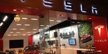 Auto dealers launch charm offensive against Tesla's direct sales