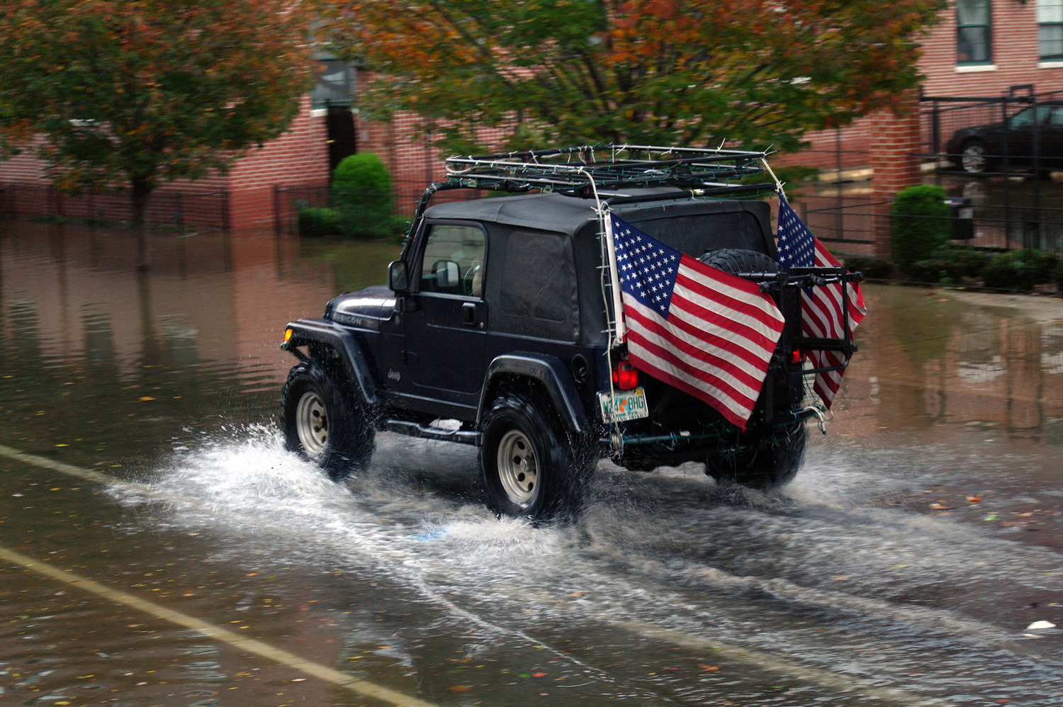 A car drives through the aftermath of Hurricane Sandy in Hoboken, New Jersey.