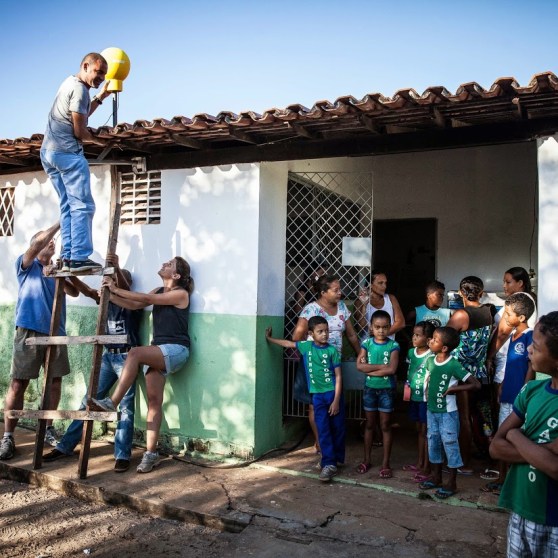 Project Loon team members install a Loon Internet antenna at a school in Brazil.