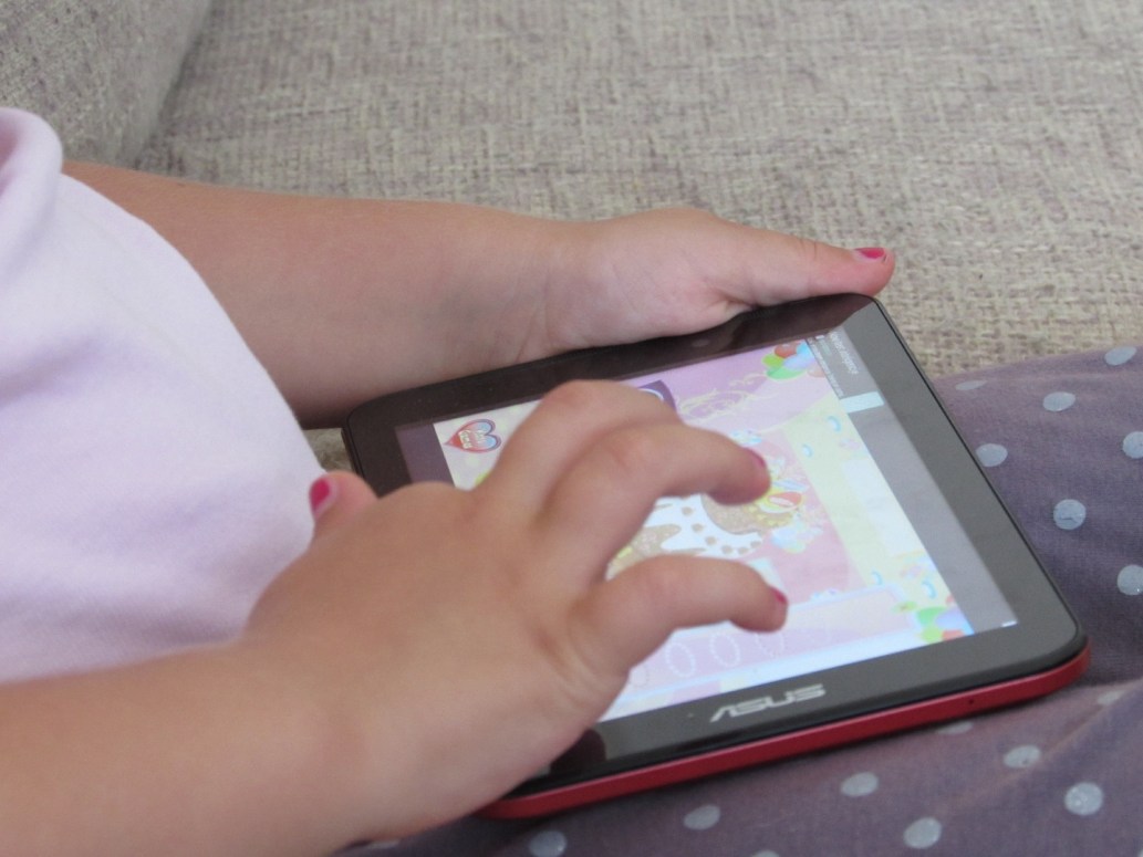 kid playing games on tablet