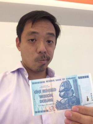 Reddit CEO Yishan Wong holding up a gift from investor and YC president Sam Altman.