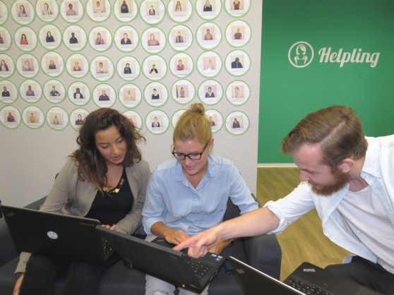Helpling employees huddle in the new offices. Behind them are Polaroid photos of cleaners who approved for the service.