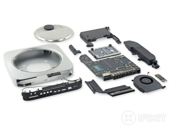 All of the 201 Mac Mini components laid out on a nice, white table.