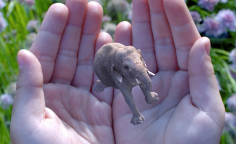 A tiny, photorealistic elephant dances in someone's hands on the Magic Leap website.