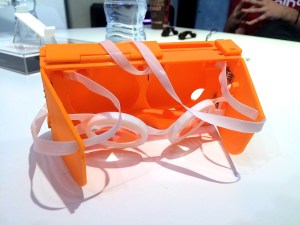 The 3D printed prototype iPhone 6 case with head-straps and suspended aspheric lenses.