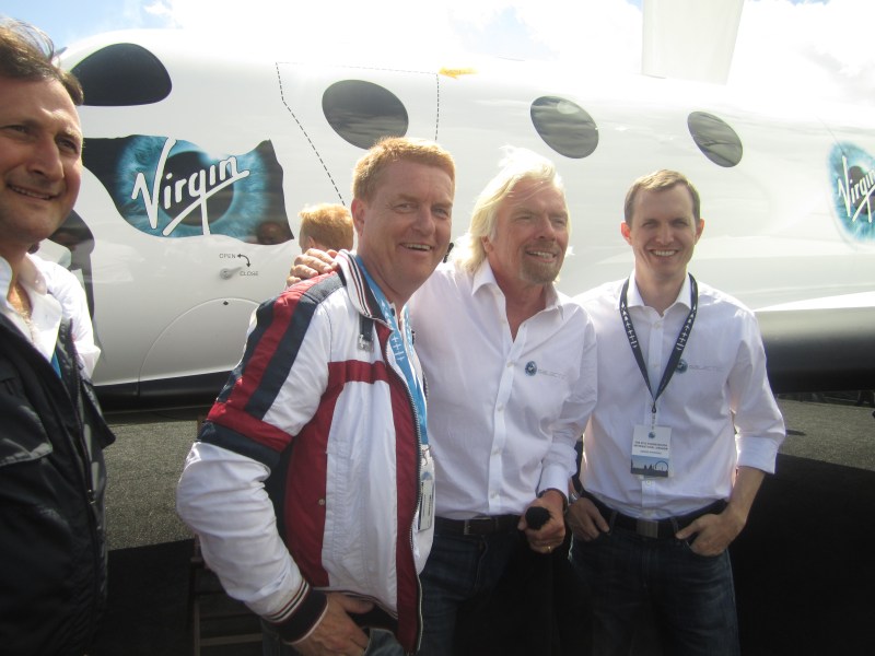 Virgin Galactic customer Gisli Gislason, left, poses for a picture in London with Virgin's Richard Branson (center).