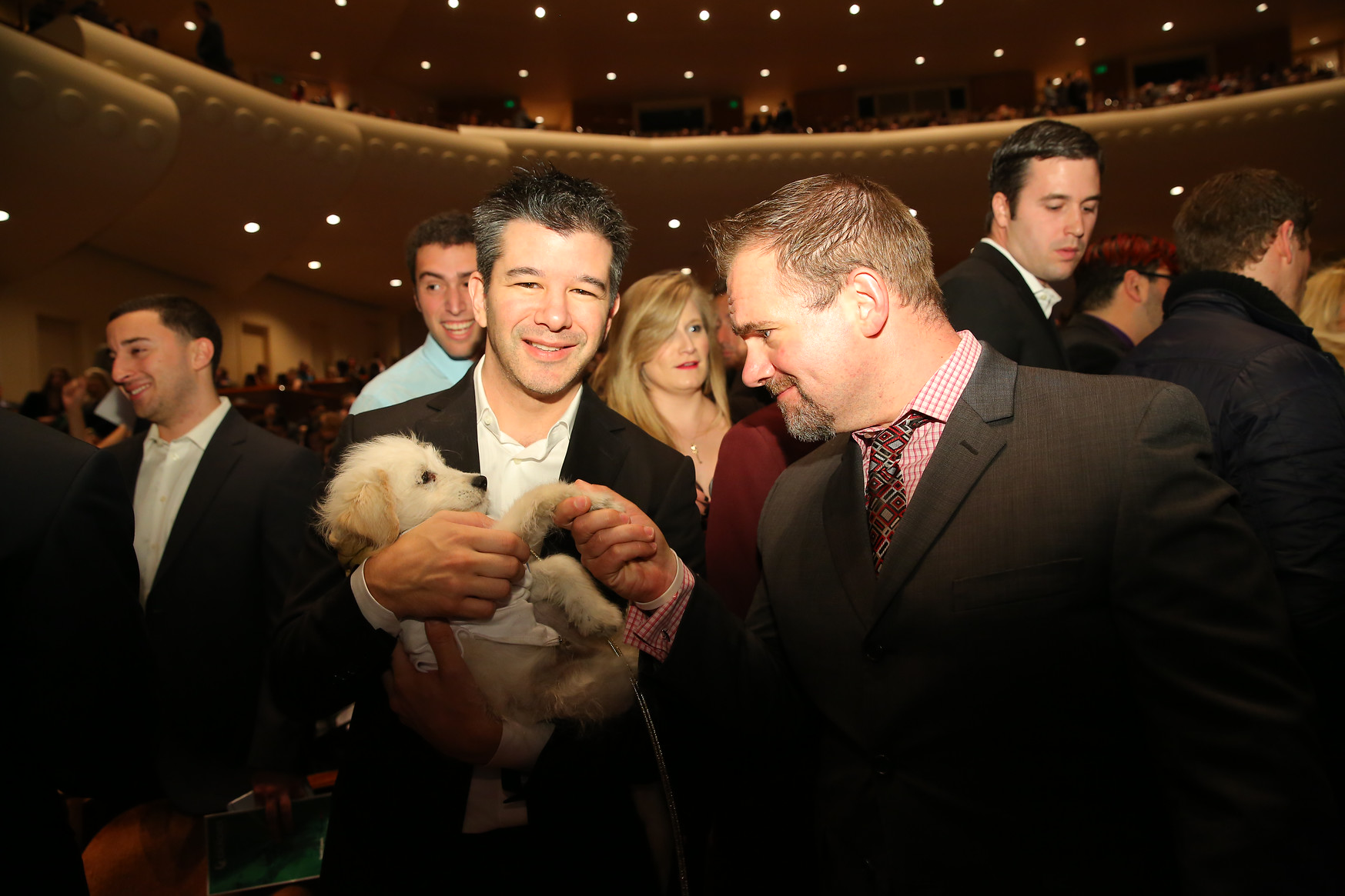 Uber CEO holding his girlfriend's dog after the Crunchies Awards Thursday night.