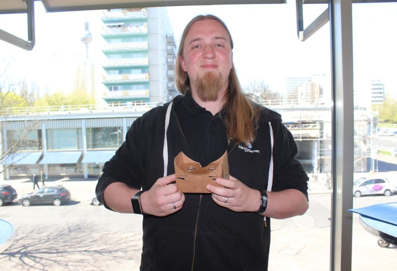 Chris Kassulke, CEO of Handy Games, holds a Google Cardboard device.