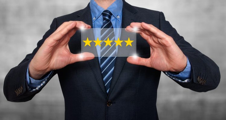pic of man in suit holding a sign with five stars