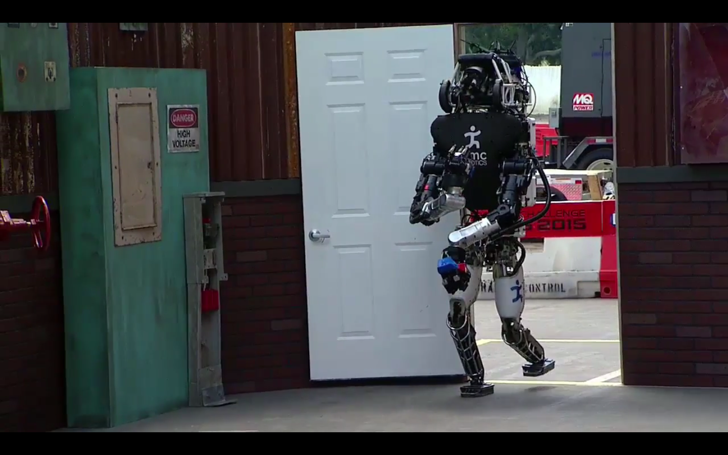 The IHMC Robotics robot opens and goes through the door during the 2015 DARPA Robotics Challenge in Pomona, Calif., on June 5.