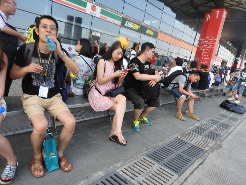 In the hot Shanghai sun, fans take a break during ChinaJoy 2015.