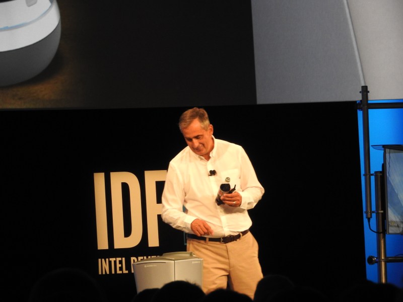 Robot brings a soda to Brian Krzanich, CEO of Intel.