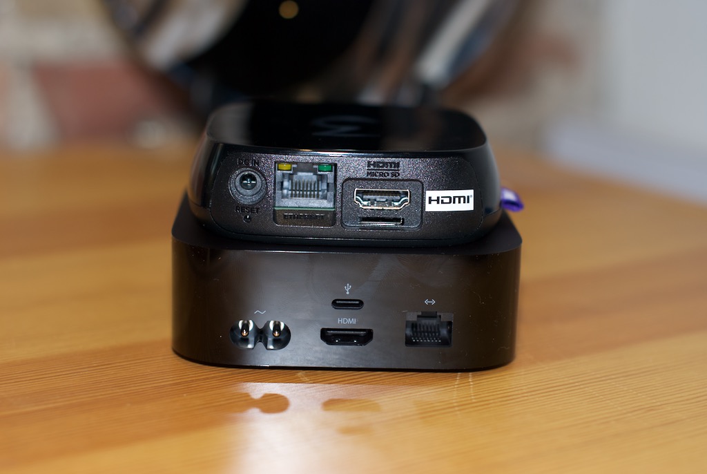 Roku 3 (above) and Apple TV 4th gen (below): Apple's remote may be the thinnest of them all, but its black box seems to have gained some pounds. Photo by Simon Cohen.